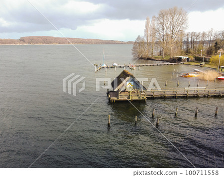 Daytime neutral density filter natural minimalist seascape pier. View of boats Daytime neutral density filter natural minimalist seascape pier. View of boats 100711558