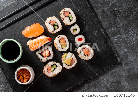 Homemade sushi rolls with salmon, shrimp, avocado. Served with soy sauce and ginger. 100712140