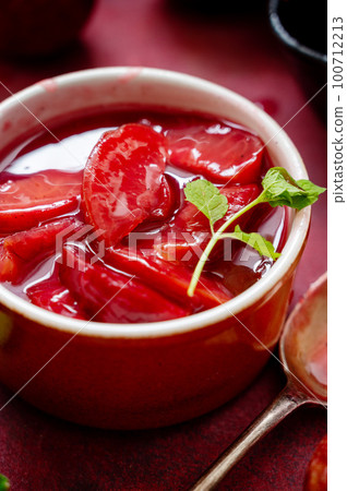 Closeup red plums confiture, jam or fruit sauce in a bowl, top voiew 100712213