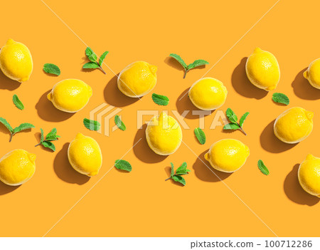 Fresh yellow lemons with mints overhead view 100712286