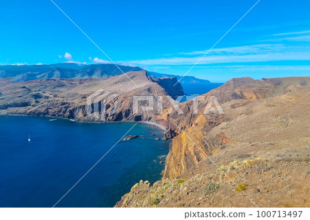 The beautiful cliffs of the island of Madeira in the Atlantic Ocean. Volcanic rocks. 100713497