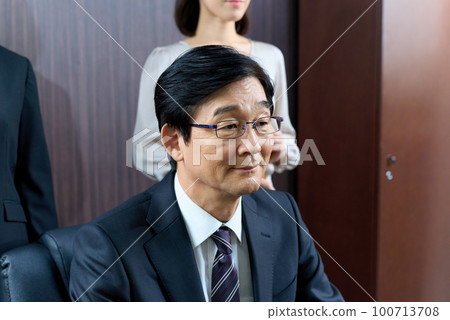 Suit manager facing business negotiations 100713708