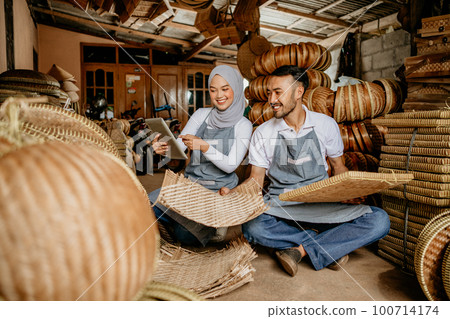 partner checking bamboo product at their traditional workshop 100714174