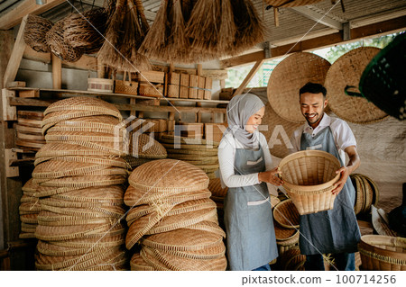 two worker at their traditional woven bamboo product two worker at their traditional woven bamboo product 100714256