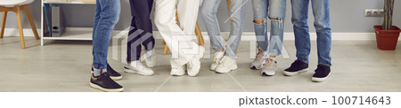 Group of young people in casual clothes and sneakers standing in row in classroom Group of young people in casual clothes and sneakers standing in row in classroom 100714643
