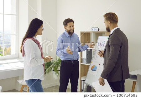 Team of three people meeting in the office and discussing their business strategy 100714692