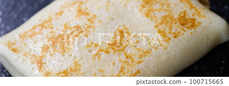Pancake stuffed with meat cheese and fruit closeup 100715665