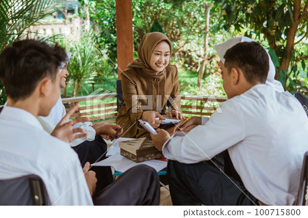 teacher in Veil guides students to do the questions 100715800