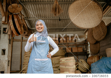 bamboo craft seller smiling to camera thumb up bamboo craft seller smiling to camera thumb up 100716033