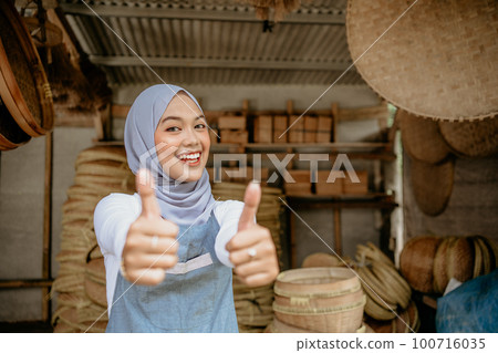 bamboo craft seller smiling to camera thumb up bamboo craft seller smiling to camera thumb up 100716035