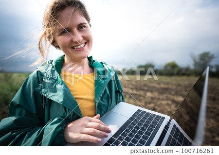 Farmer with laptop on the field.  100716261