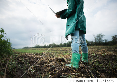 Farmer with laptop on the field. Farmer with laptop on the field. 100716270