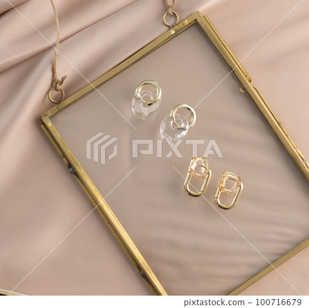 Elegant jewelry set of gold earrings. Jewelry set minimalist style. Handmade bijouterie concept. Elegant jewelry set of gold earrings. Jewelry set minimalist style. Handmade bijouterie concept. 100716679