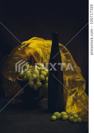 Still life with grapes, wine and yellow cloth 100717389