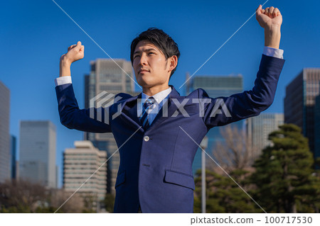 Businessman raising both hands Businessman raising both hands 100717530
