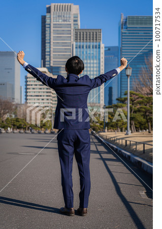 Businessman raising both hands Businessman raising both hands 100717534