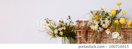 Wicker basket filled with wildflowers. Wicker basket filled with wildflowers. 100718915