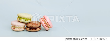Sweet macaroons in pastel colors isolated on blue background. 100718926