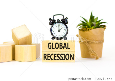 Global recession symbol. Concept words Global recession on wooden blocks. Beautiful white table white background. Black alarm clock. House plant. Business and global recession concept. Copy space. Global recession symbol. Concept words Global recession on wooden blocks. Beautiful white table white background. Black alarm clock. House plant. Business and global recession concept. Copy space. 100719367