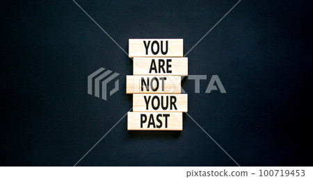 You are not your past symbol. Concept words You are not your past on wooden blocks. Beautiful black table black background. Business and you are not your past concept. Copy space. 100719453