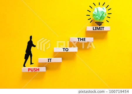 Push it to the limit symbol. Concept words Push it to the limit on wooden blocks. Beautiful yellow table yellow background. Businessman icon. Business push it to the limit concept. Copy space. Push it to the limit symbol. Concept words Push it to the limit on wooden blocks. Beautiful yellow table yellow background. Businessman icon. Business push it to the limit concept. Copy space. 100719454