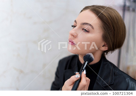 Close up portrait of a woman making up Close up portrait of a woman making up 100721304
