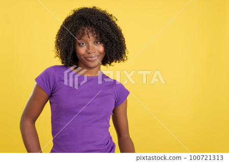 Woman with afro hair smiling at camera 100721313