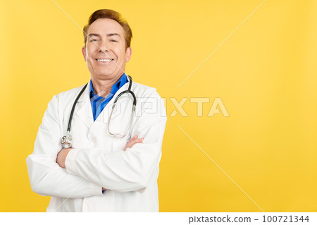 Mature doctor looking at the camera with arms crossed Mature doctor looking at the camera with arms crossed 100721344