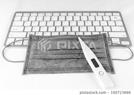 Keyboard, mask and thermometer. Image of computer infected with virus 100723666