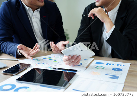 financial, Planning, Marketing and Accounting, Asian young Economist using calculator to calculate investment documents with partners on profit taking to compete with other companies. 100723772