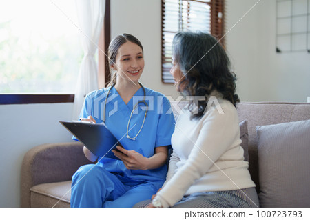 Portrait of a female doctor holding a patient clipboard to discuss and analyze the patient's condition before treating 100723793