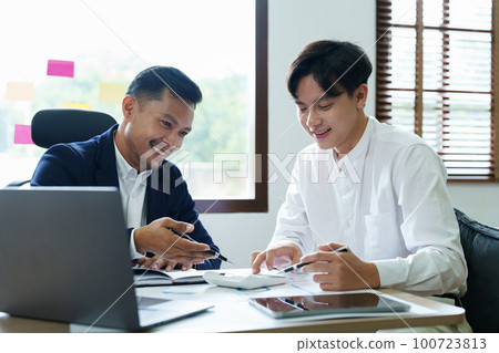 financial, Planning, Marketing and Accounting, Asian young Economist using calculator to calculate investment documents with partners on profit taking to compete with other companies 100723813
