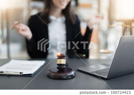 Portrait of a Asian woman lawyer studying lawsuit a for a client using computer laptop , documents to video conference before going to court Portrait of a Asian woman lawyer studying lawsuit a for a client using computer laptop , documents to video conference before going to court 100724423