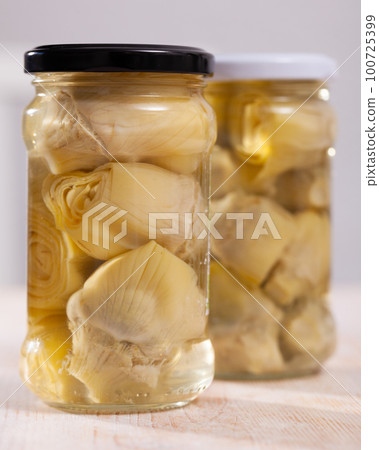 Pickled artichokes in glass jar Pickled artichokes in glass jar 100725399