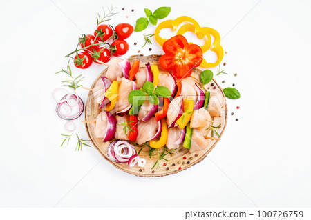 Chicken Skewers breast fillet meat.Uncooked mixed meat skewer.Skewers with pieces of raw meat,red,yellow,green pepper.Top view.Raw chicken skewers with vegetables,peppers,onions,on a white background. 100726759