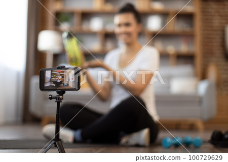 Sportswoman participating in remote training programme Sportswoman participating in remote training programme 100729629