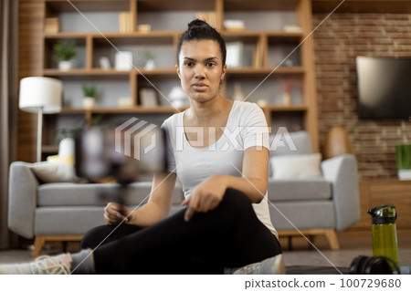 Sports blogger conducting remote fitness training online 100729680