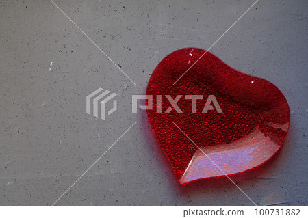 A plate in the shape of a heart on grey background A plate in the shape of a heart on grey background 100731882