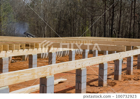 Work on new custom homes concrete block foundation installing wood floor joists trusses 100732923
