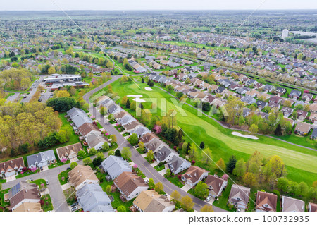 An aerial view of small American town you can see residential complex, houses, and roads 100732935