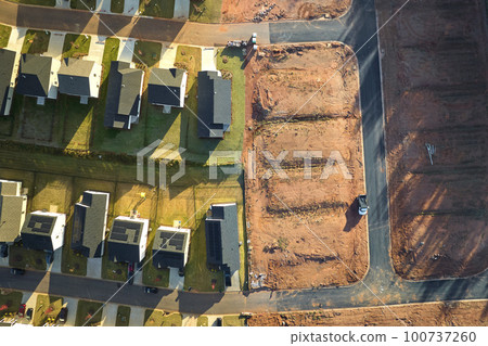 View from above of densely built residential houses under construction in south Carolina residential area. American dream homes as example of real estate development in US suburbs View from above of densely built residential houses under construction in south Carolina residential area. American dream homes as example of real estate development in US suburbs 100737260
