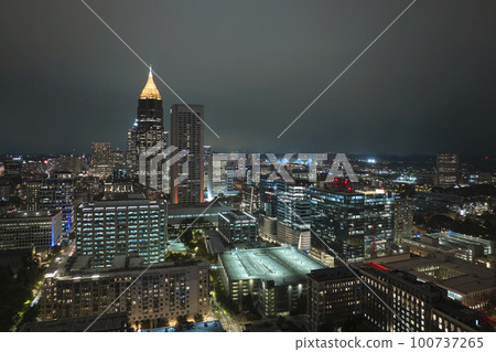 View from above of brightly illuminated high skyscraper buildings in downtown district of Atlanta city in Georgia, USA. American megapolis with business financial district at night 100737265