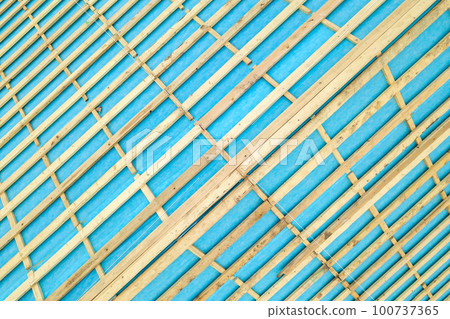 Top down detail of a wooden roof frame on a house under construction. Top down detail of a wooden roof frame on a house under construction. 100737365