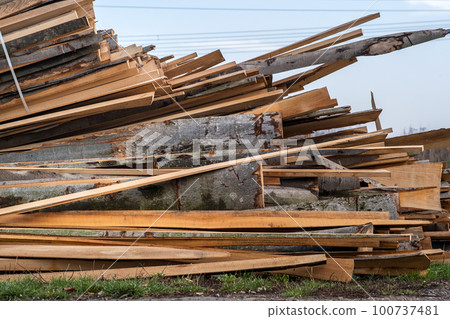 Stack od wooden boards prepared for cutting by chainsar for firewood. Stack od wooden boards prepared for cutting by chainsar for firewood. 100737481