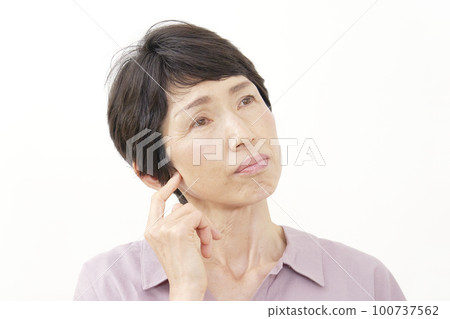 Middle-aged woman thinking white background 100737562
