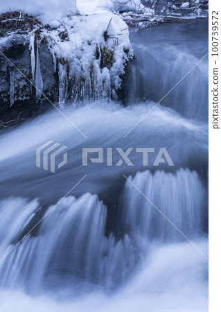 Frozen stream and icicles Frozen stream and icicles 100739572