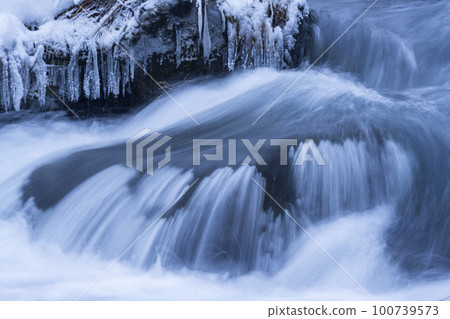A frozen stream that shines blue A frozen stream that shines blue 100739573