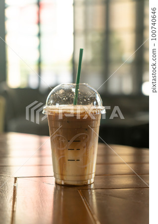 caramel macchiato coffee cup in coffee shop 100740646