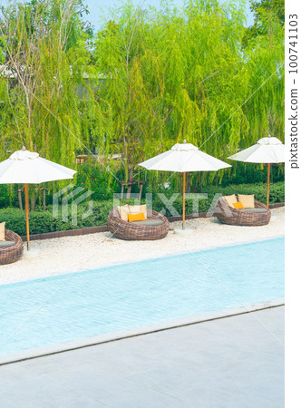 outdoor patio chair with pillow and umbrella around swimming pool outdoor patio chair with pillow and umbrella around swimming pool 100741103