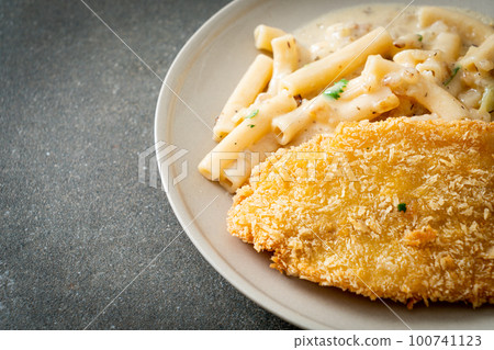 quadrotto penne pasta white cream sauce with fried fish 100741123